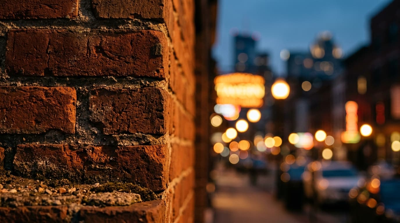 An extreme close-up macro of a weathered, vintage-style brick wall on Franklin Street, bathed in golden hour light, with t...