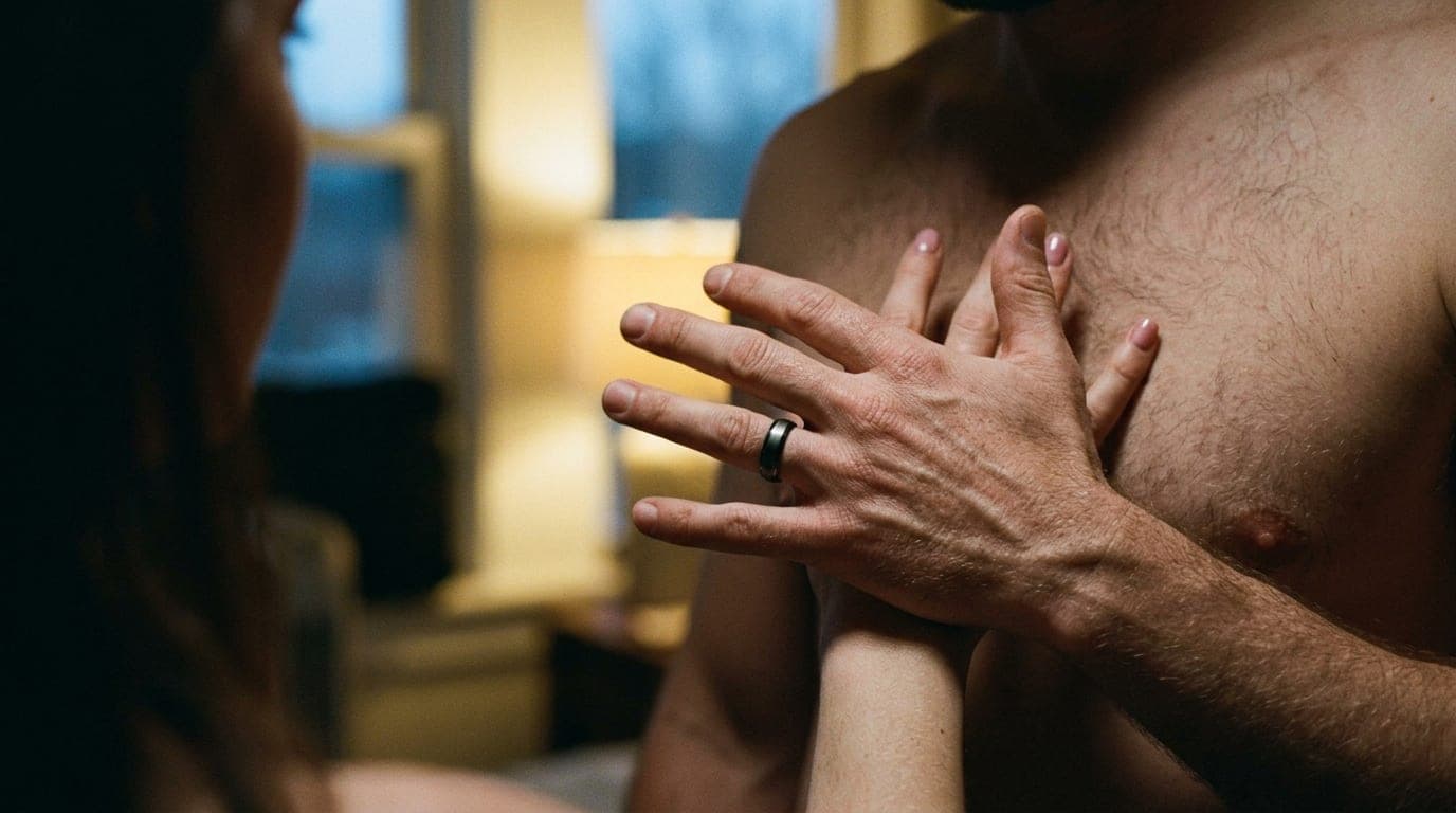 A close-up shot of a hand gently pushing away a partner’s palm from a bare chest. Dim blue hour light highlights the tensi...